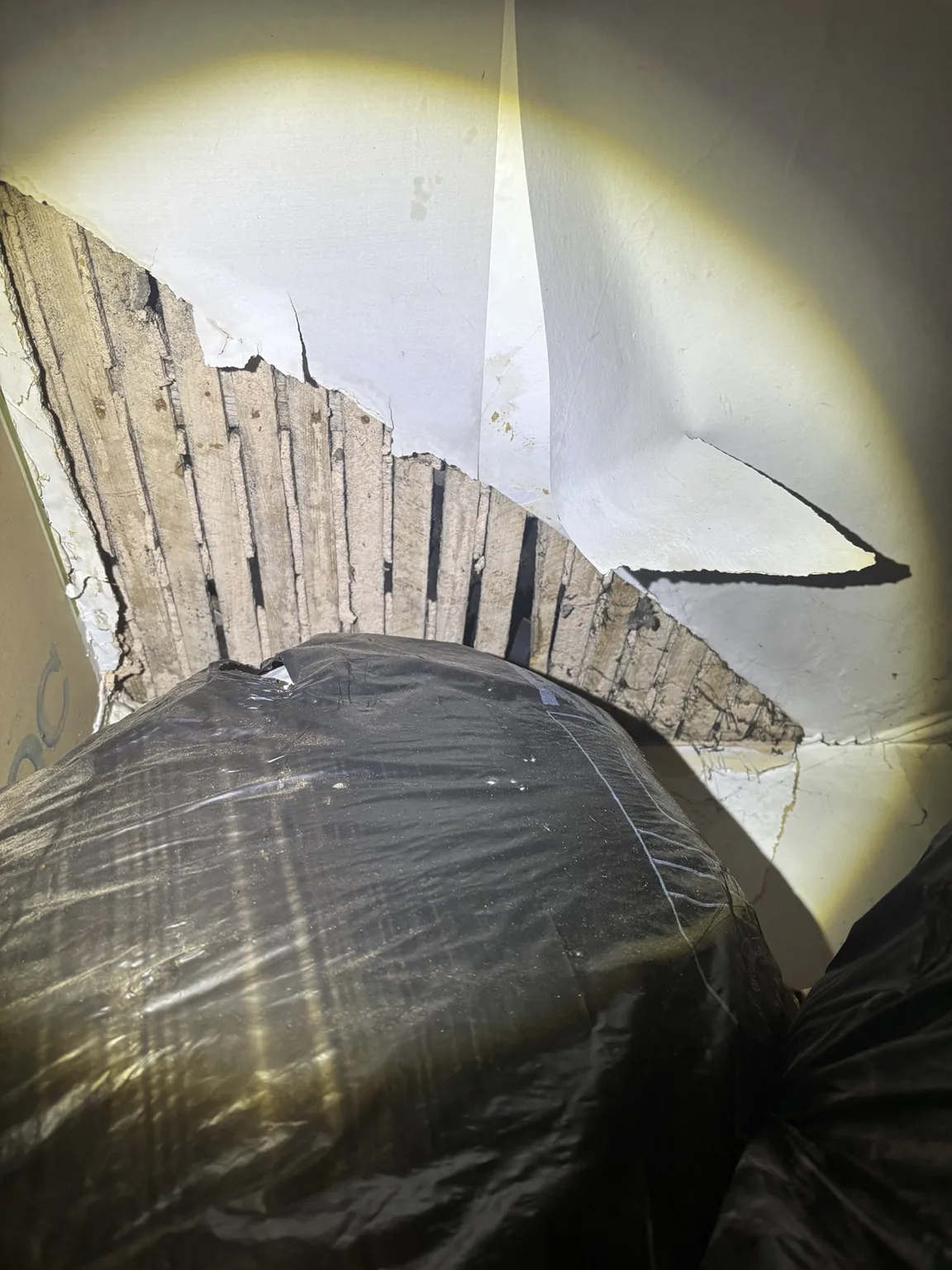Exposed laths following water damage to a ceiling